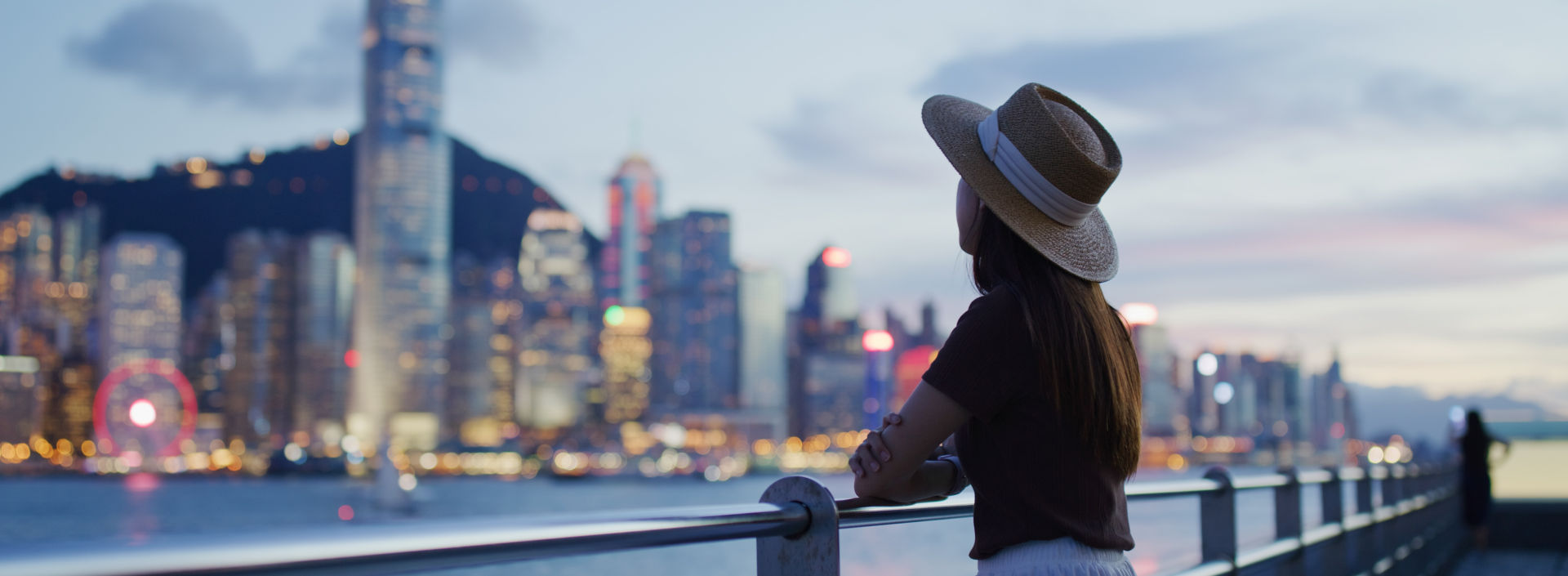Woman enjoying the view of Hong Kong at night.